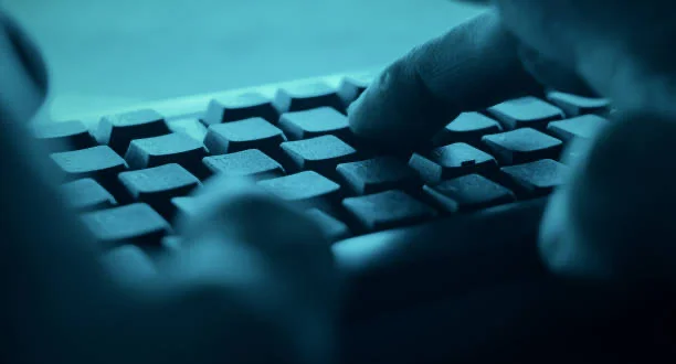 Hands typing on desktop pc computer keyboard