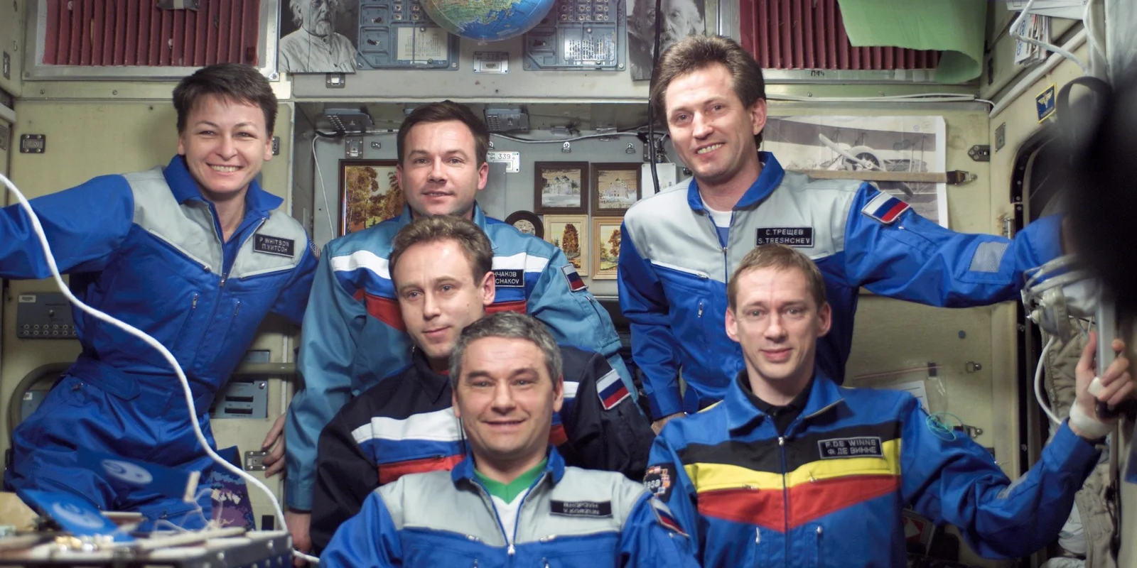Soyuz Five and Expedition Five crew pose in the SM during Expedition Five on the ISS