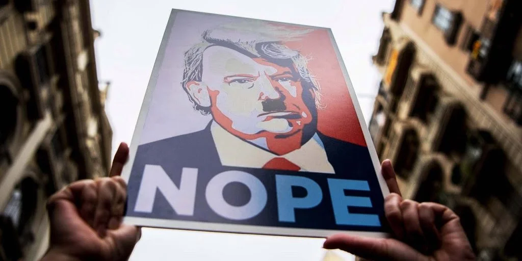 Donald-Trump-fascist-Hitler-protest-sign-GettyImages-632281520