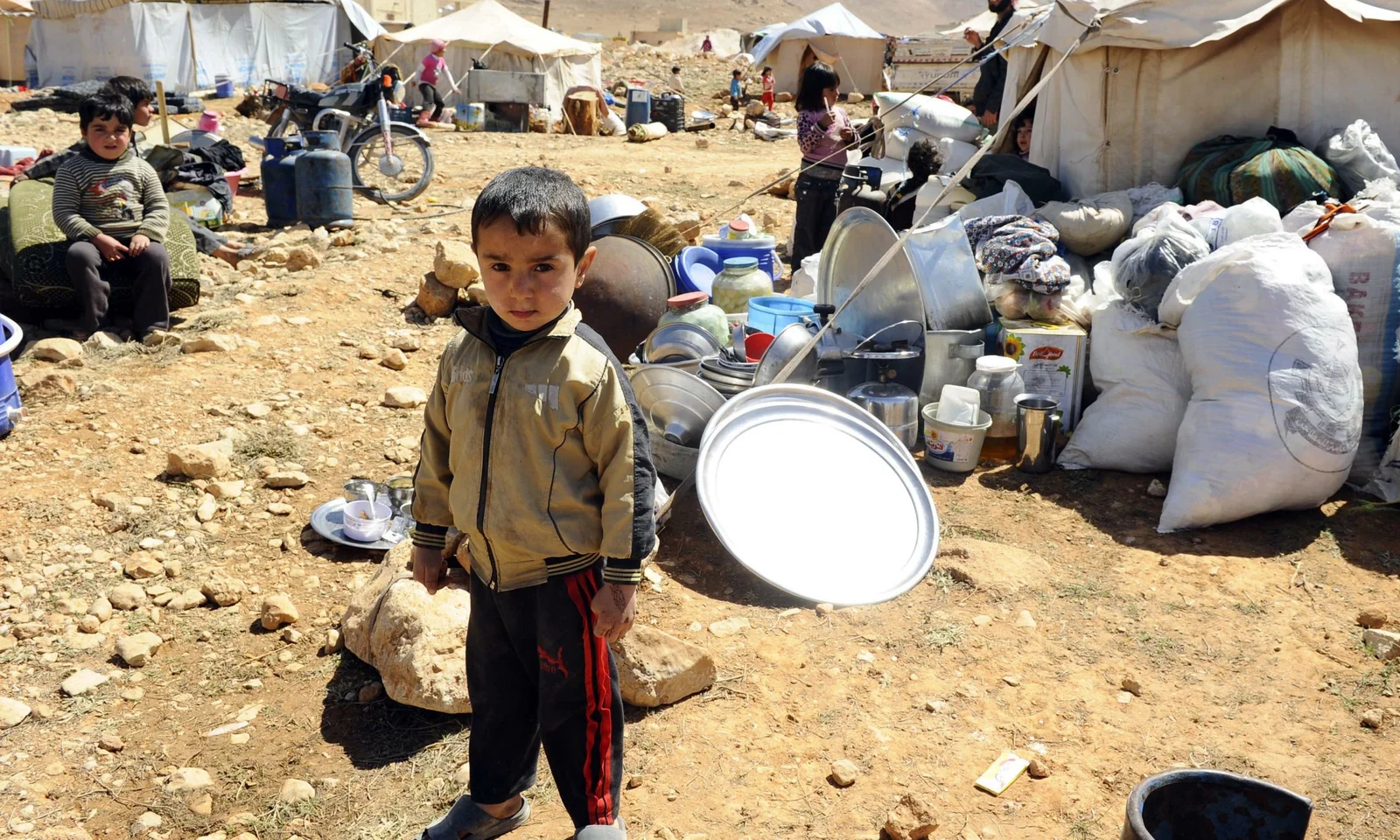 A Syrian refugee child who fled the violence from the Syrian town of Flita, near Yabroud, poses for a photograph at the border town of Arsal